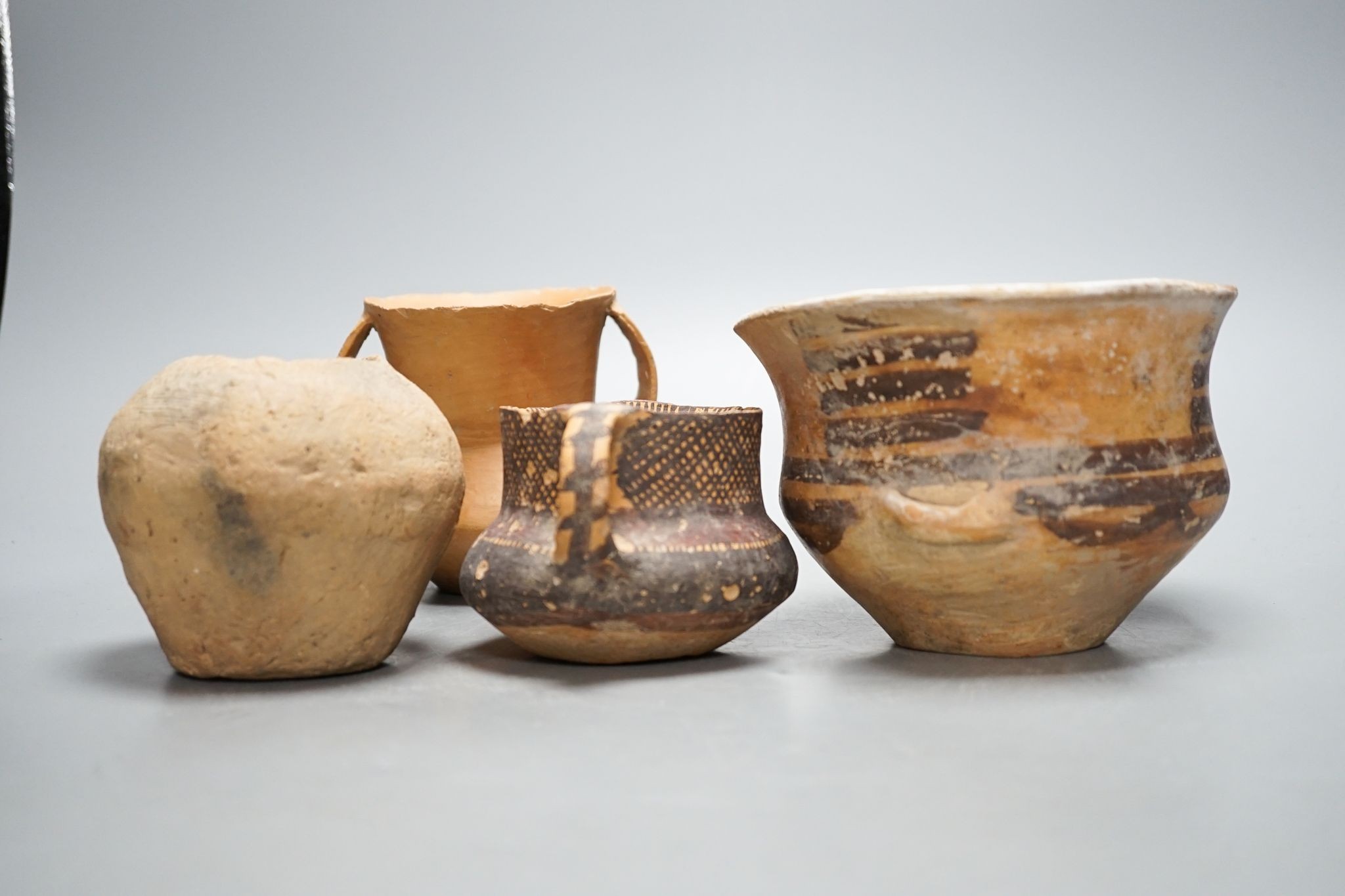 Four Chinese Neolithic pottery vessels, 11cm